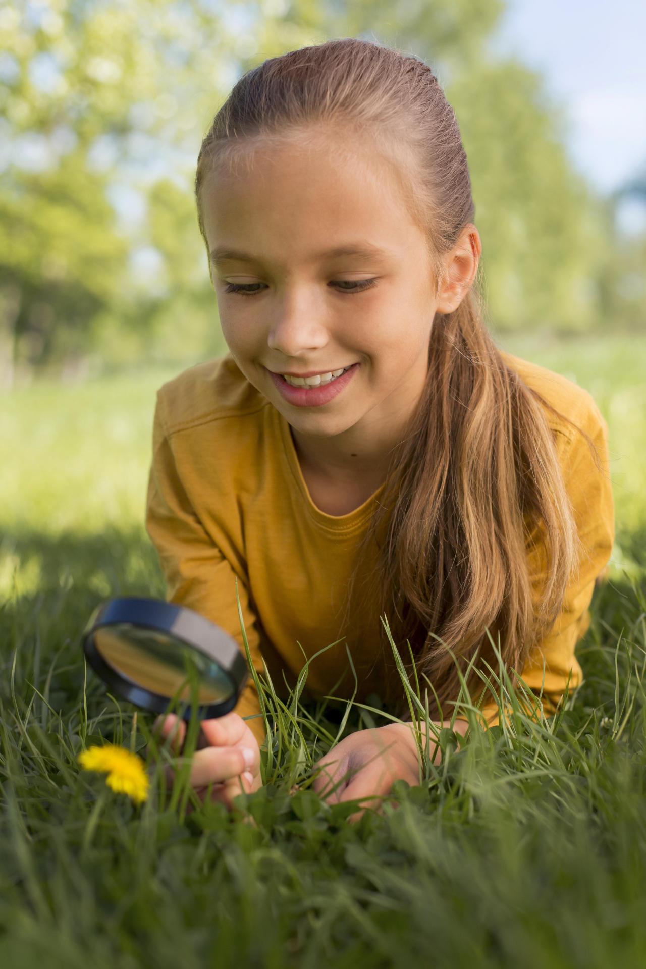 Medium shot girl observing flower